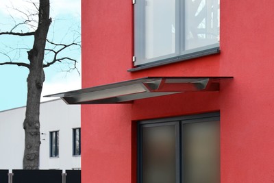 Design Vordach Skala an roter Fassade